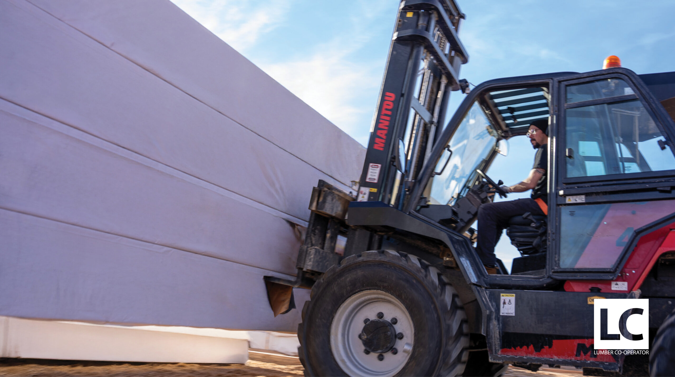 Forklift driver moving building materials on jobsite