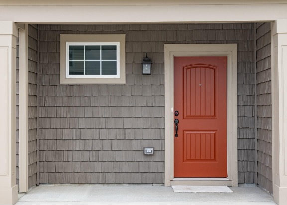 Red door with gray shingles